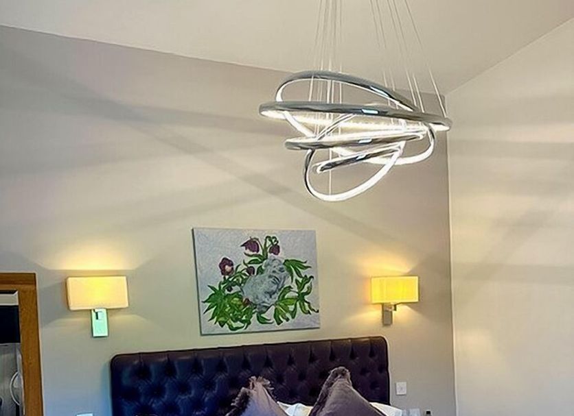 The Oak Tree Inn York bedroom with king bed, wall art, bedside lamps and modern pendant light