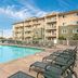 Worldmark Long Beach poolside view with outdoor pool, lounge chairs, and apartment-style balconies