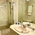 Shs Hotel Aeropuerto Madrid bathroom with bathtub, glass shower screen, and sink