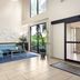 La Quinta Inn & Suites by Wyndham Bonita Springs Naples N lobby with seating, glass doors and plant