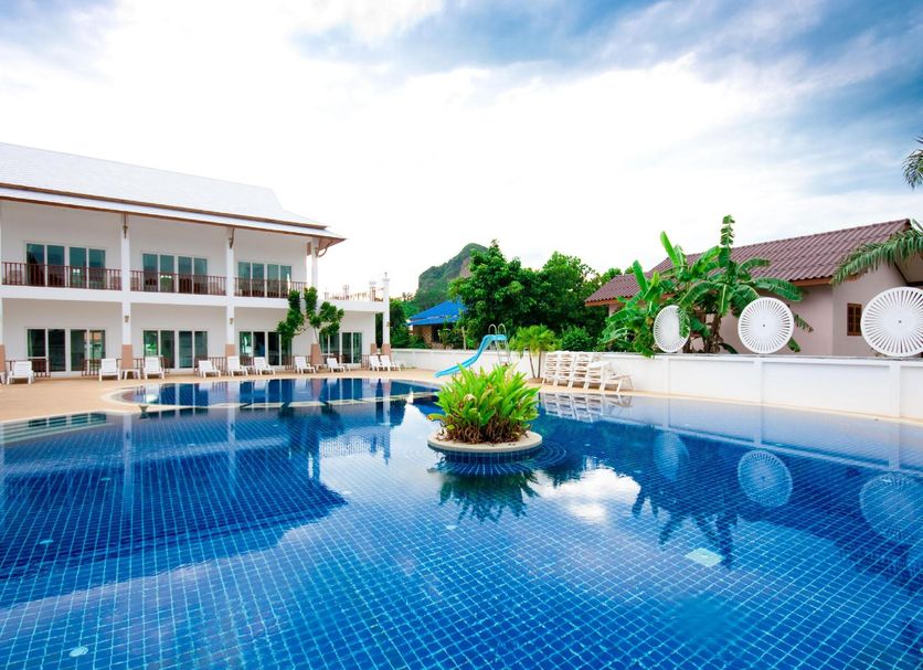 Nadivana Serviced Apartment in Krabi with a large outdoor pool and poolside lounge chairs