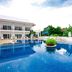 Nadivana Serviced Apartment in Krabi with a large outdoor pool and poolside lounge chairs