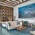 The Capitana Key West lobby with curved wood ceiling, blue seating, and ocean-themed wall art