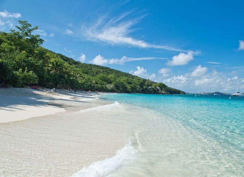 Inn at Tamarind Court in St. John: white-sand beach with turquoise water and green hillside