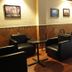 Gran Hotel Paris in La Ceiba lounge with black chairs, small tables, wall art and tiled floor