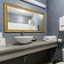 Hollywood Palms Inns & Suites bathroom with vessel sink, gold-framed mirror, and folded towels in Los Angeles