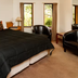 Fitzherbert Castle Motel Palmerston North guest room with king bed, armchair and windows