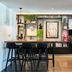 citizenM Rome Isola Tiberina lounge with bar stools, art display and teal chairs in Rome