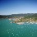 Beach Court Holiday Villas in Airlie Beach overlooking turquoise bay with many sailboats and green hills