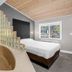 The Inn at Boatworks, Tahoe City: guest room with heart-shaped soaking tub, bed and Lake Tahoe view