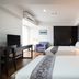 Lily Hotel Bangkok in Bangkok guest room with two beds, desk, TV and armchair