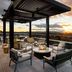 Sunset rooftop terrace at Moxy Asheville Downtown in Asheville with fire pit seating and city views