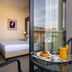 iH Hotels Milano Watt 13 Milan guest room with balcony breakfast tray and city view