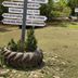 Kinabalu Poring Vacation Lodge in Kundasang, signpost in garden with tire planter and trees