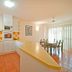 Beach Court Holiday Villas in Airlie Beach: bright kitchen and dining area with orange tile floor