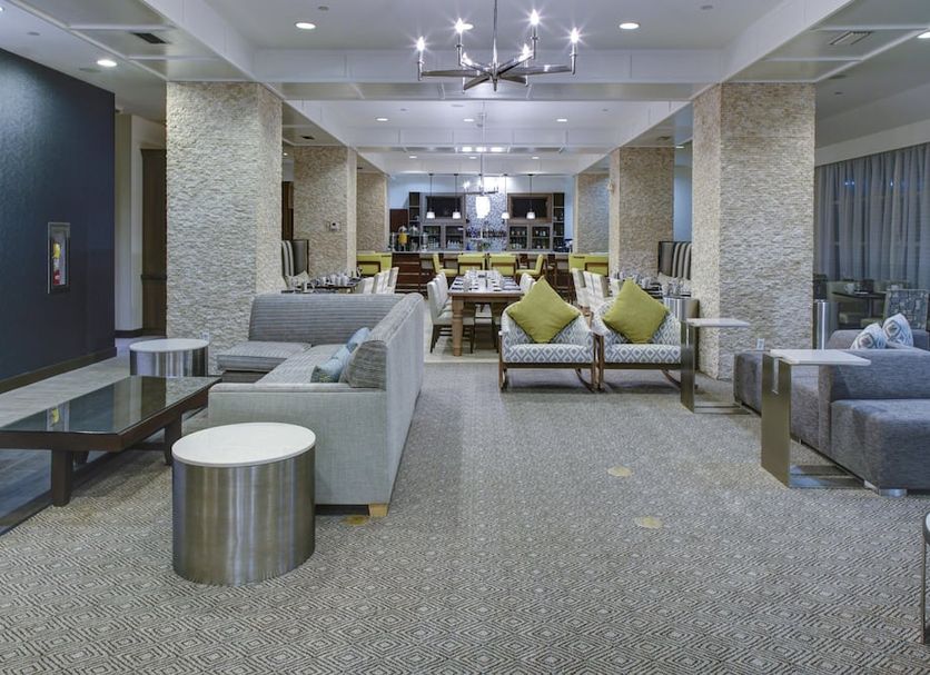 DoubleTree by Hilton Biloxi lobby seating area with modern lounge chairs, sofas and dining tables