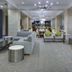 DoubleTree by Hilton Biloxi lobby seating area with modern lounge chairs, sofas and dining tables