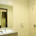 Akasa Hotel Pakem bathroom with shower, sink, mirror and toilet