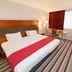 Holiday Inn Newport by IHG guest room with double bed, desk, chair, and striped carpet in Newport