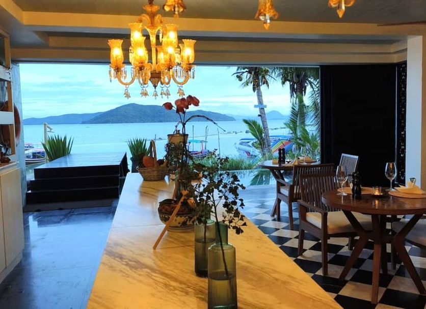The Beach Samui in Ko Samui features a sea-view dining area with chandelier and patio opening to the beach.