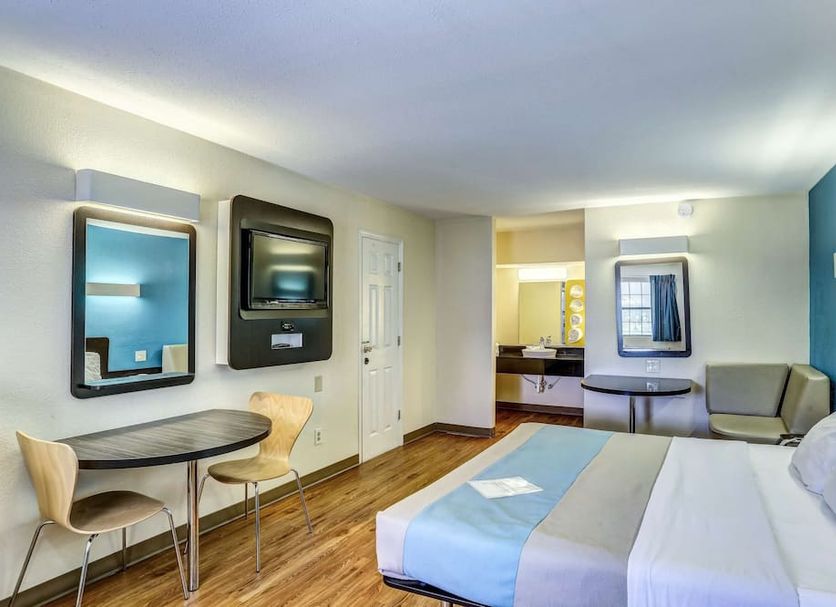 Motel 6 Dickson, TN room with queen bed, desk, chair, and wall-mounted TV