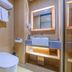 Ji Hotel Shenzhen Shennan Avenue Huaqiang bathroom with walk-in shower, wall-mounted sink and toilet in Shenzhen