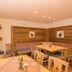 Hotel Alpspitz B&B Grainau lounge with fireplace, wooden seating, and rustic wall decor