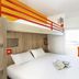 hotelF1 Amiens Est in Glisy: compact room with bunk bed, double bed, desk, chair and wall-mounted TV