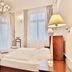 Sun Palace Wellness Hotel in Mariánské Lázně: elegant guest room with chandelier and tall windows