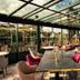 Ermitage - Mont-Saint-Michel in Beauvoir: glass-enclosed restaurant with bar seating and garden views