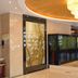 Yiwu Mango Hotel in Jinhua lobby with chandelier, decorative glass doors and seating area
