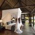 Kayumanis Jimbaran Private Estate & Spa in South Kuta, canopy bed suite with tropical garden views