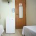 Flat Econômico Hotel São Paulo Butantã Usp room with two beds, mini fridge and wooden door