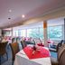 Twin Towers Inn in Artarmon dining room with red table settings and large windows