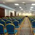 Golden Tulip Kumasi City conference hall with rows of blue and gold chairs in Kumasi