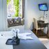 Do-Do Navona Suites room in Rome with window seat, desk, and bed tray folded into a swan.