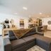 First Class Hotel Medellín lounge with sectional sofa, bar counter, and dining tables