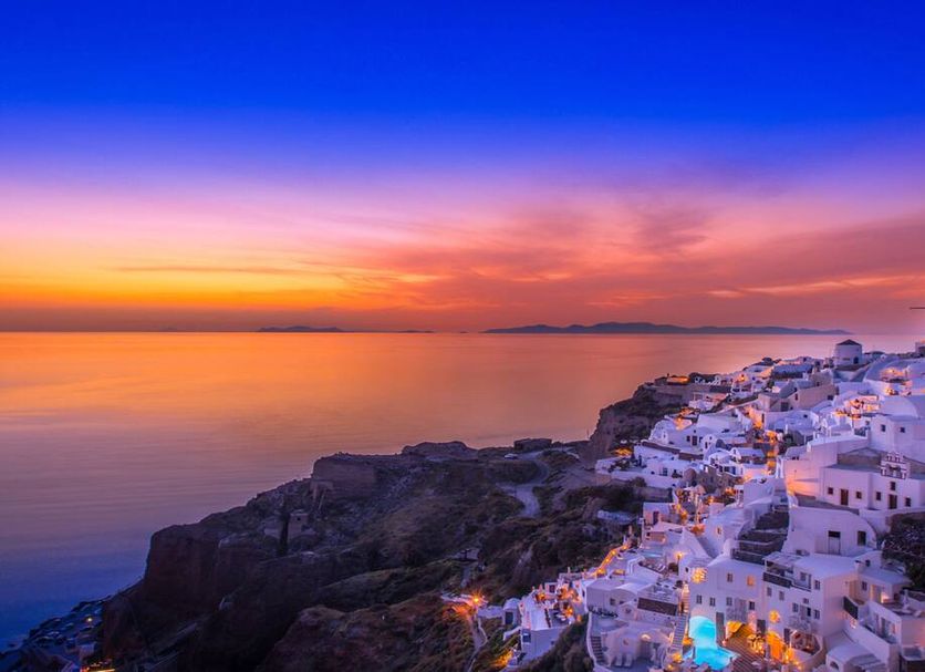 Santorini Secret Suites & Spa in Thera with cliffside white suites overlooking a sunset sea view