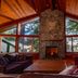 The Cabins at Terrace Beach in Ucluelet, cozy lodge lounge with stone fireplace and forest views