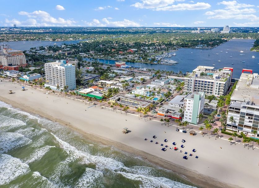 Hollywood Beachside Boutique Suites in Hollywood with oceanfront beach, waves, and city skyline view