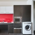 Abode Woden, Canberra: compact kitchenette with red backsplash, microwave, sink and washing machine