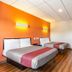 Motel 6 Elizabeth NJ Newark Liberty Intl Airport room with two beds and wall-mounted TV in Elizabeth
