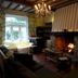 La Maison De Maitre in Arbrefontaine, cozy lounge with lit fireplace, chandelier and window seat