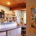 Haka Lodge Christchurch kitchen area with shelves, microwave, counter, and a colorful wall poster