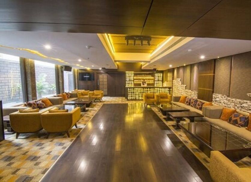 Hotel Centre Point in Nagpur lobby with seating areas, warm lighting, and polished wood flooring