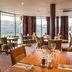 Premier Inn Nottingham Arena - London Road restaurant with tables and chairs by large windows in Nottingham