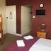 The Kings Arms London room with bunk beds, double bed, wall-mounted TV and bedside table