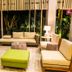 The Nest Hotel Nusa Dua, South Kuta lounge with sofas, ottoman, lamp and tropical greenery