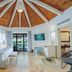 Grand Palladium White Sand Resort & Spa in Akumal guest room with vaulted wood ceiling and balcony doors