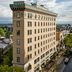The Flat Iron Hotel in Asheville, tall historic building on a city street with mountain views